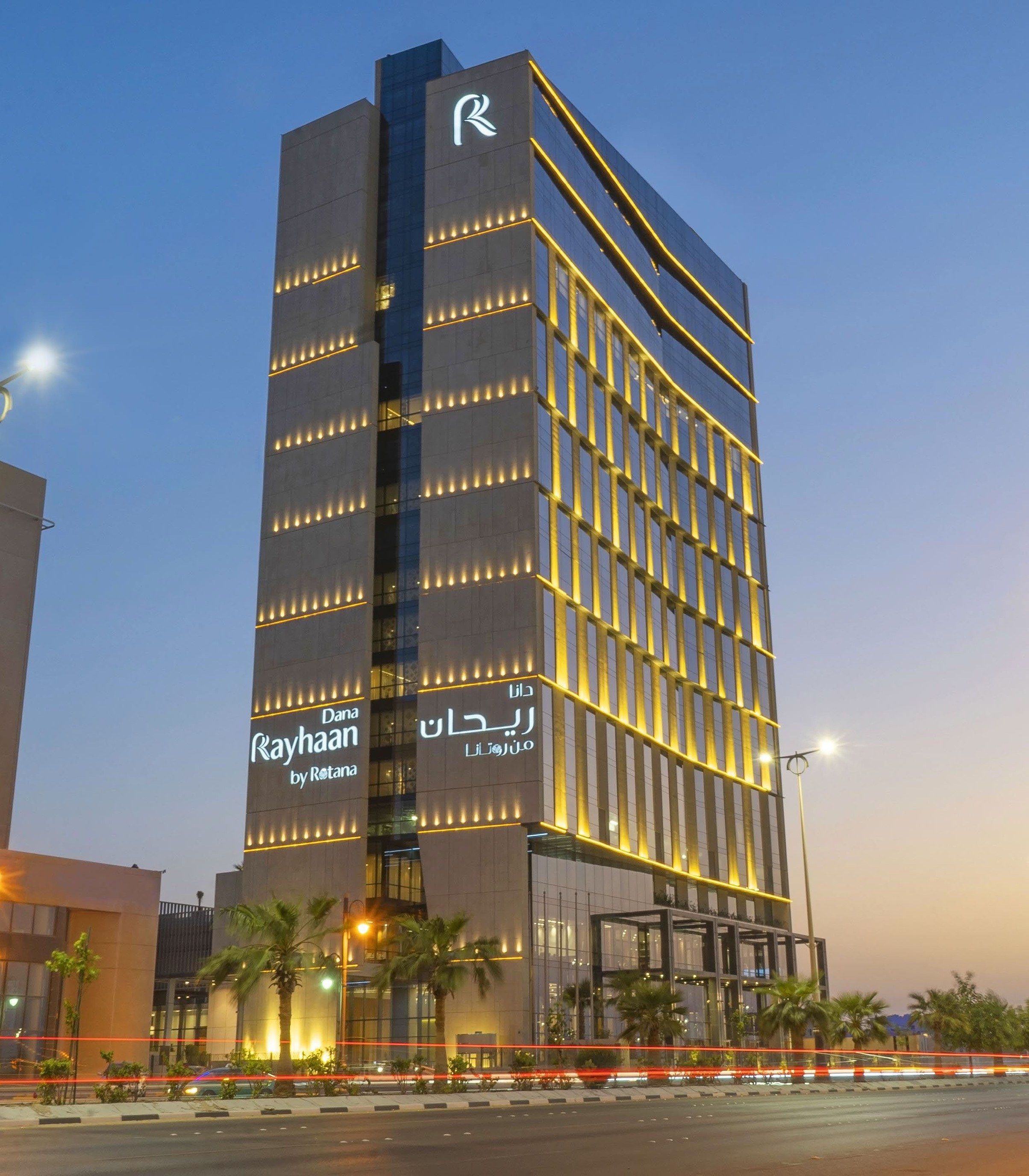 Centro Corniche by Rotana lit at dusk