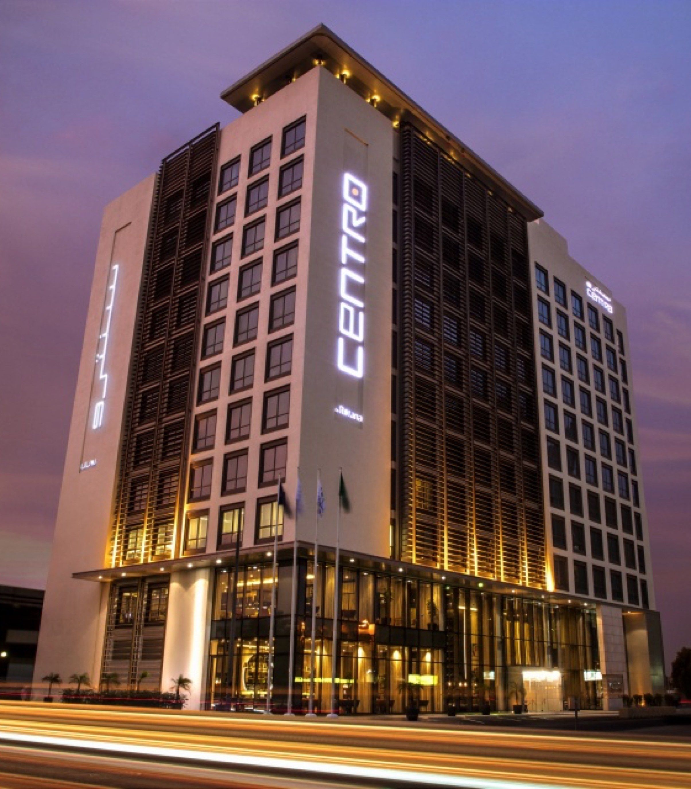 Centro Shaheen by Rotana lit at dusk