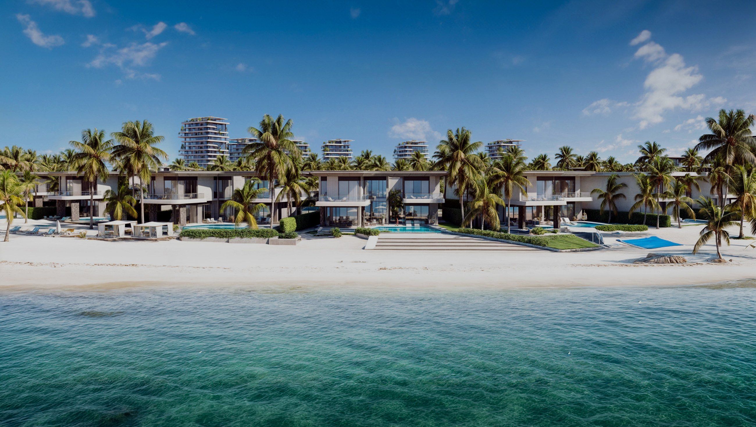 The beach at La Perla, with villas behind the palms