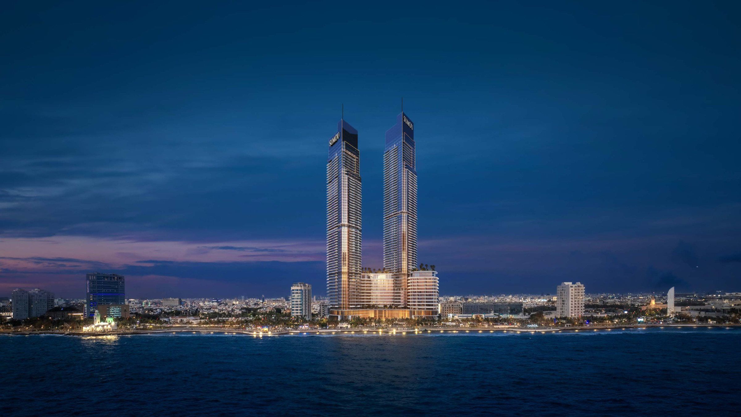 The towers at dusk across the water