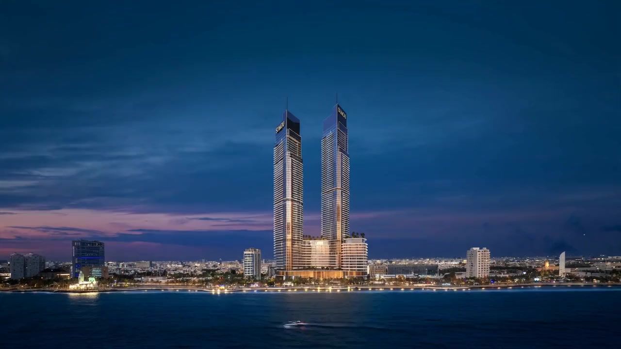 Sumou Towers at sunset, the sun setting between the two towers over the sea